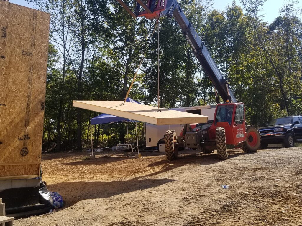 Skytrak used during SIPs construction. SIPs promote energy-efficiency.